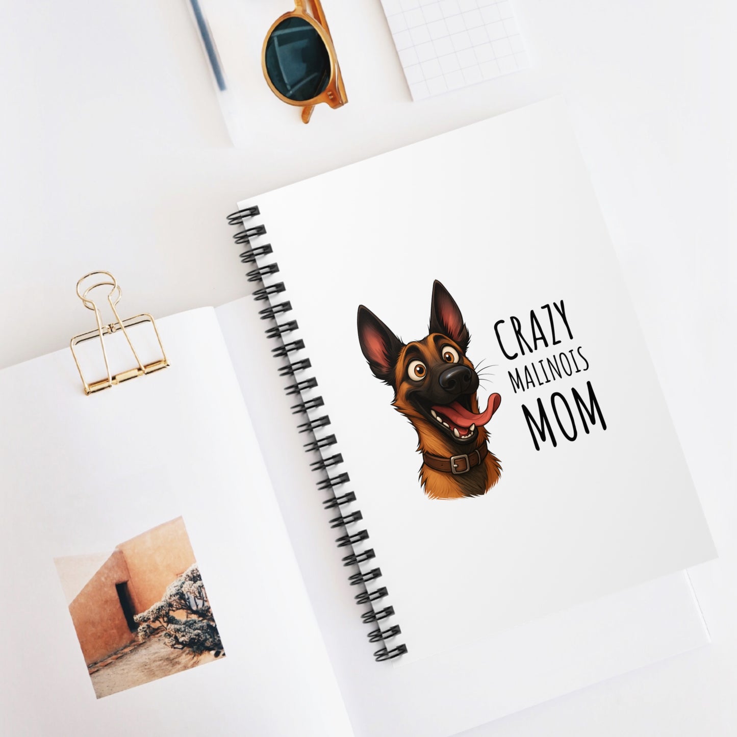 Notebook with a dog illustration and text on a white surface