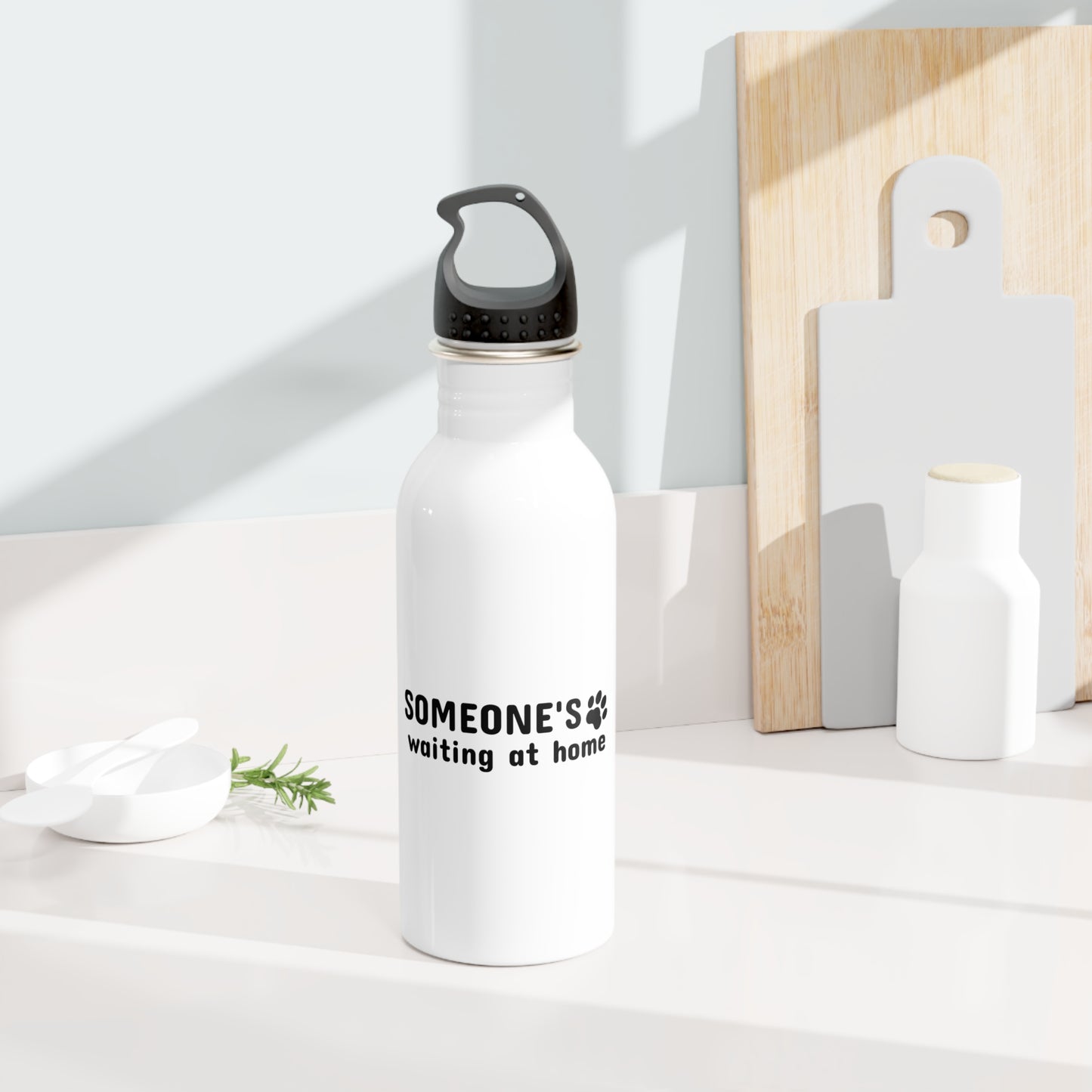 White water bottle with text on a white surface with wooden cutting boards in the background