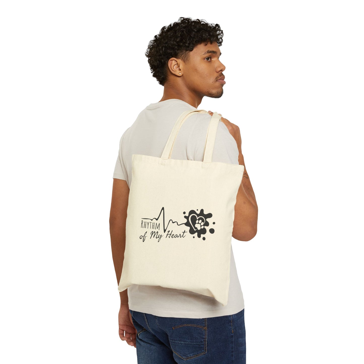 Man carrying a white tote bag with a design and text on a white background