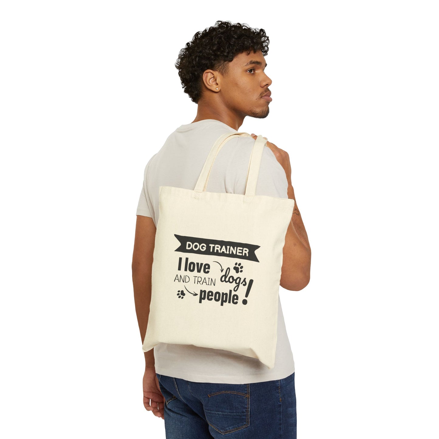 Man carrying a tote bag with 'Dog Trainer' text and design.