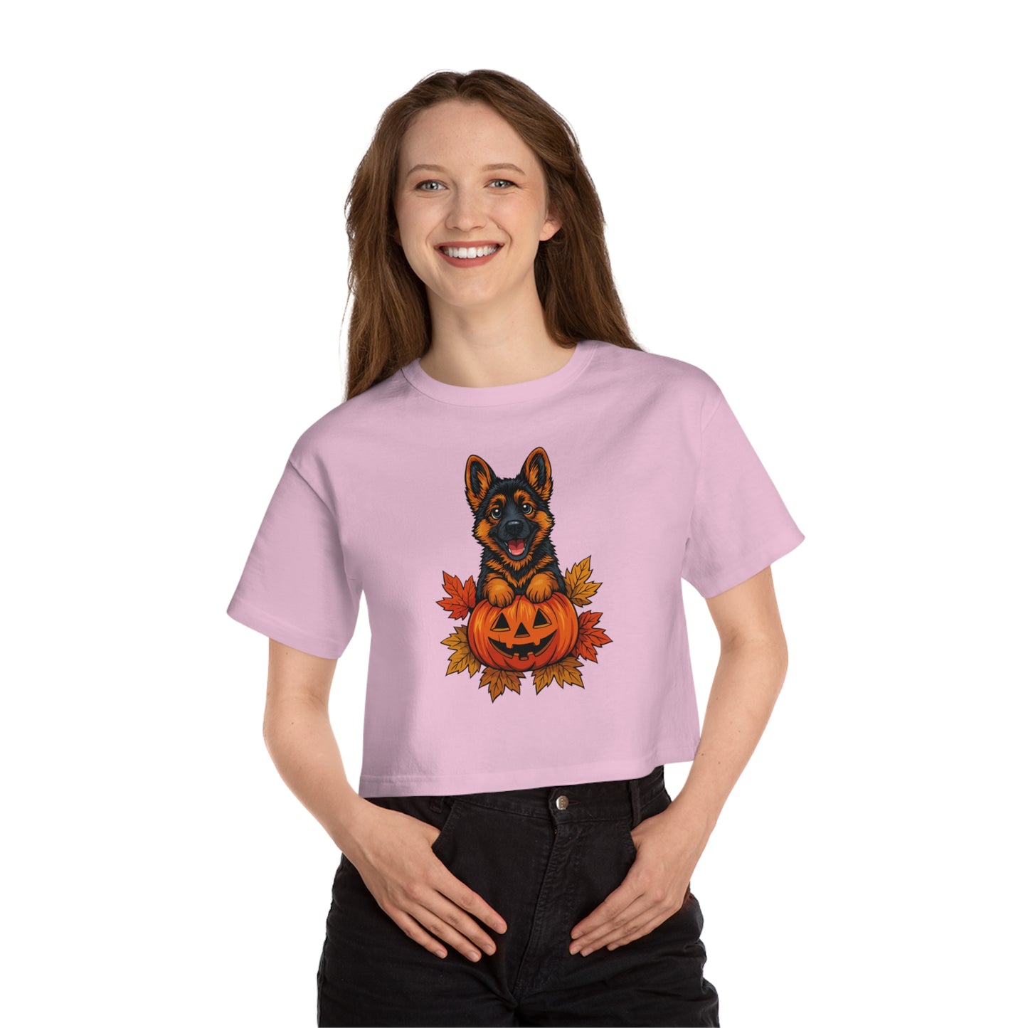 Person wearing a pink t-shirt with a Halloween-themed design of a dog in a pumpkin.