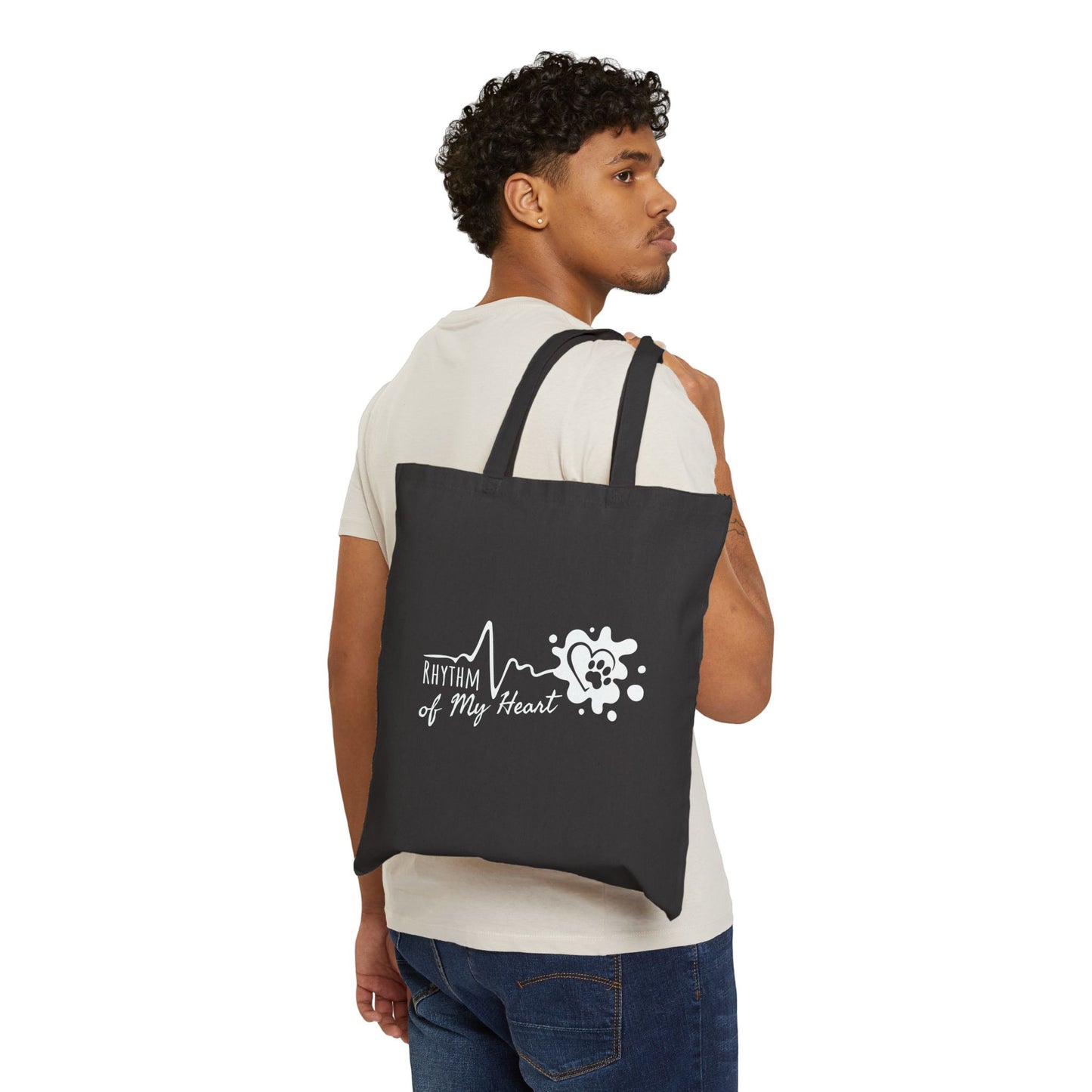 Man carrying a black tote bag with a design and text on a white background
