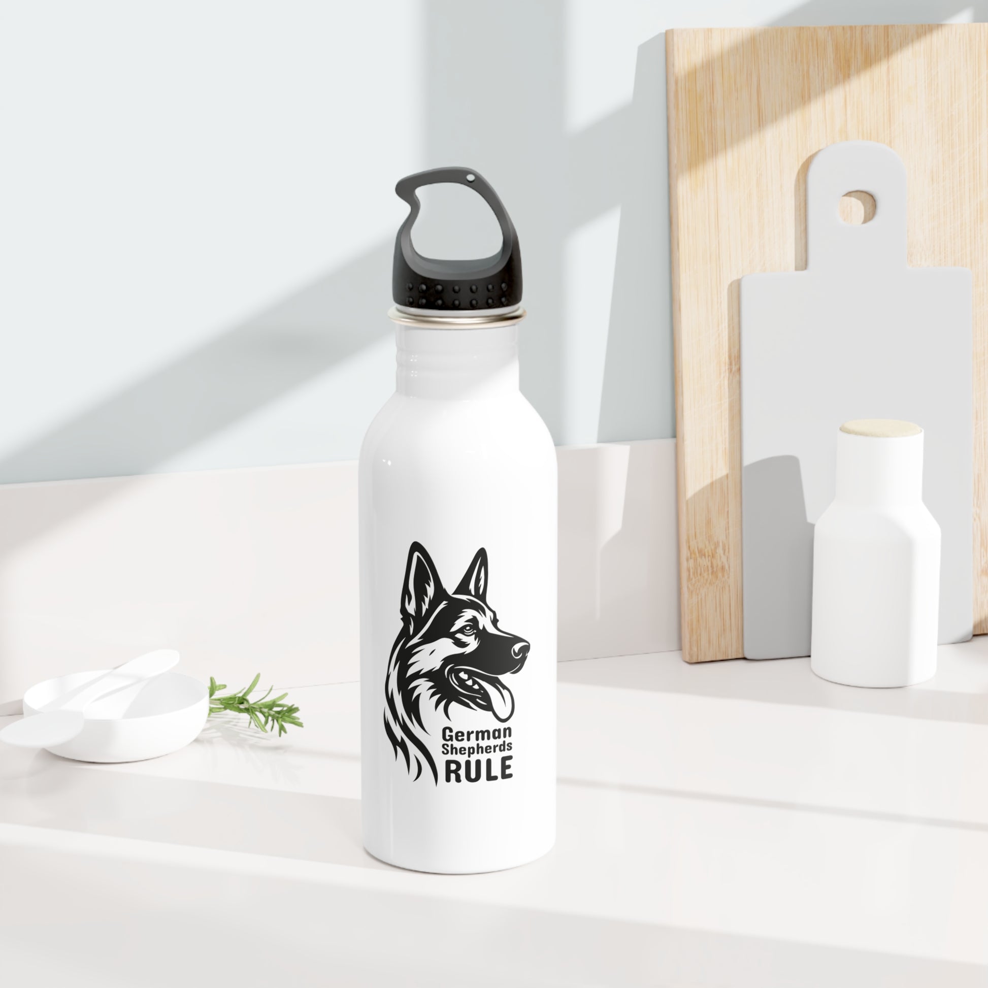 White water bottle with black dog illustration and text on a white surface