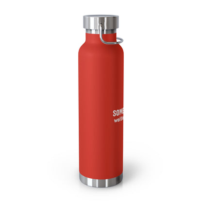 Red water bottle with silver lid and handle on a white background