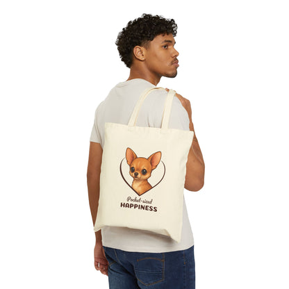 Man holding a tote bag with a dog illustration and text on a white background