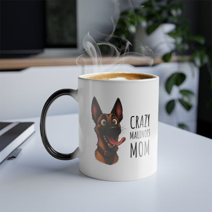 Mug with a dog illustration and 'Crazy Malinois Mom' text, steaming hot on a desk.