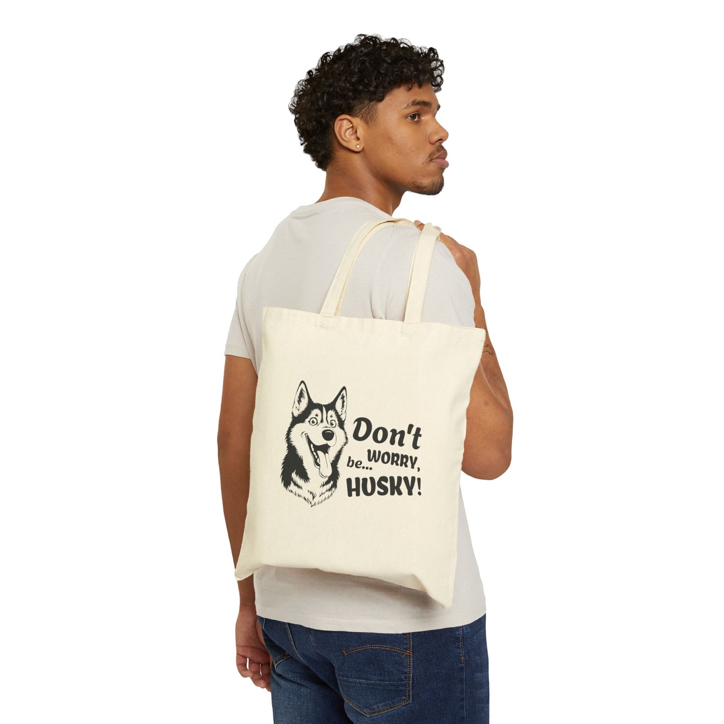 Man carrying a tote bag with a husky design and text on a white background