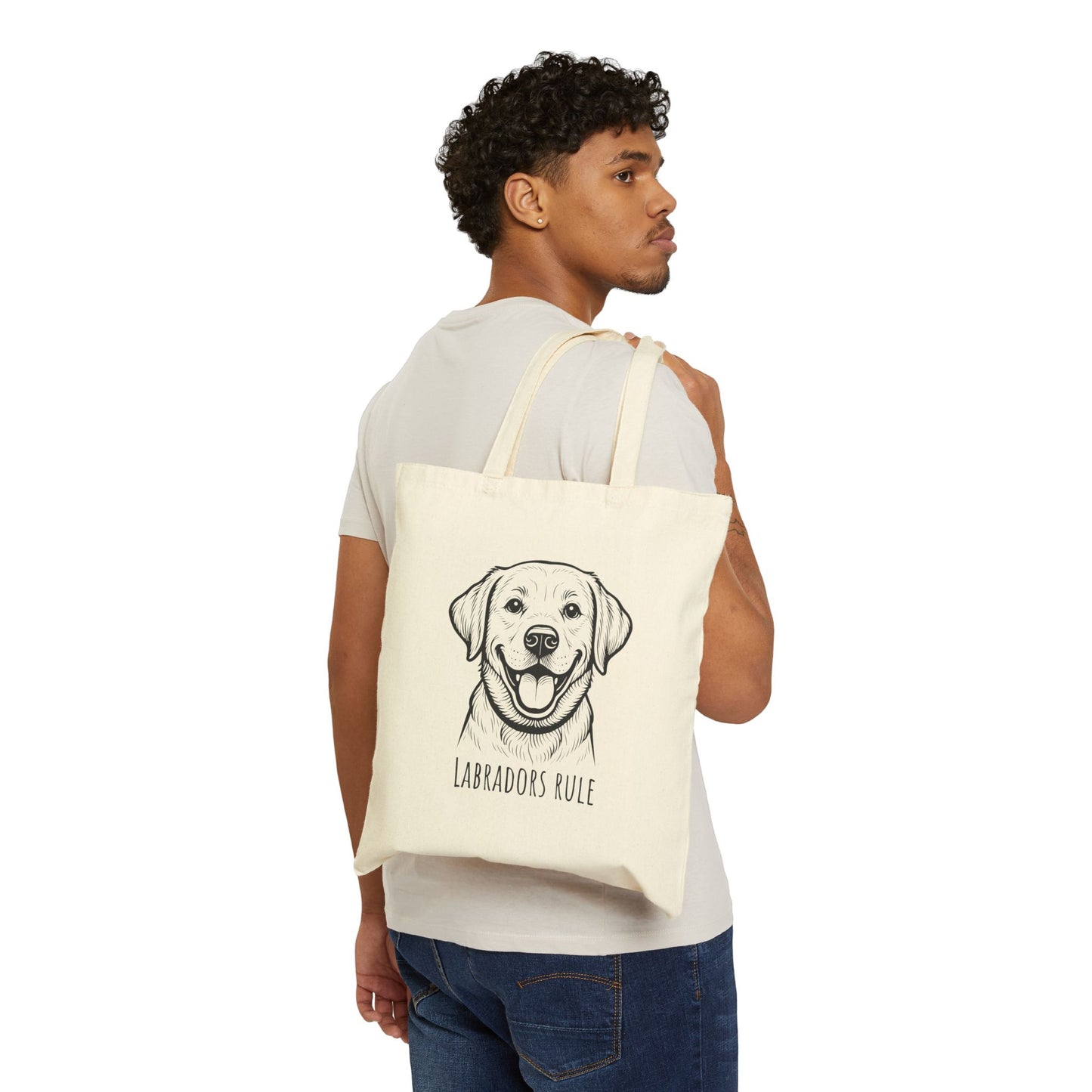 Man holding a tote bag with a Labrador illustration and 'Labradors Rule' text on a white background