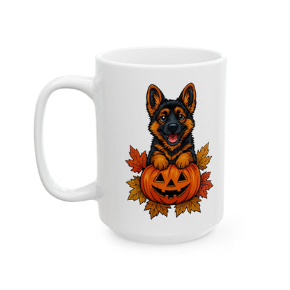 White mug with a design of a German Shepherd dog sitting on a pumpkin surrounded by autumn leaves.