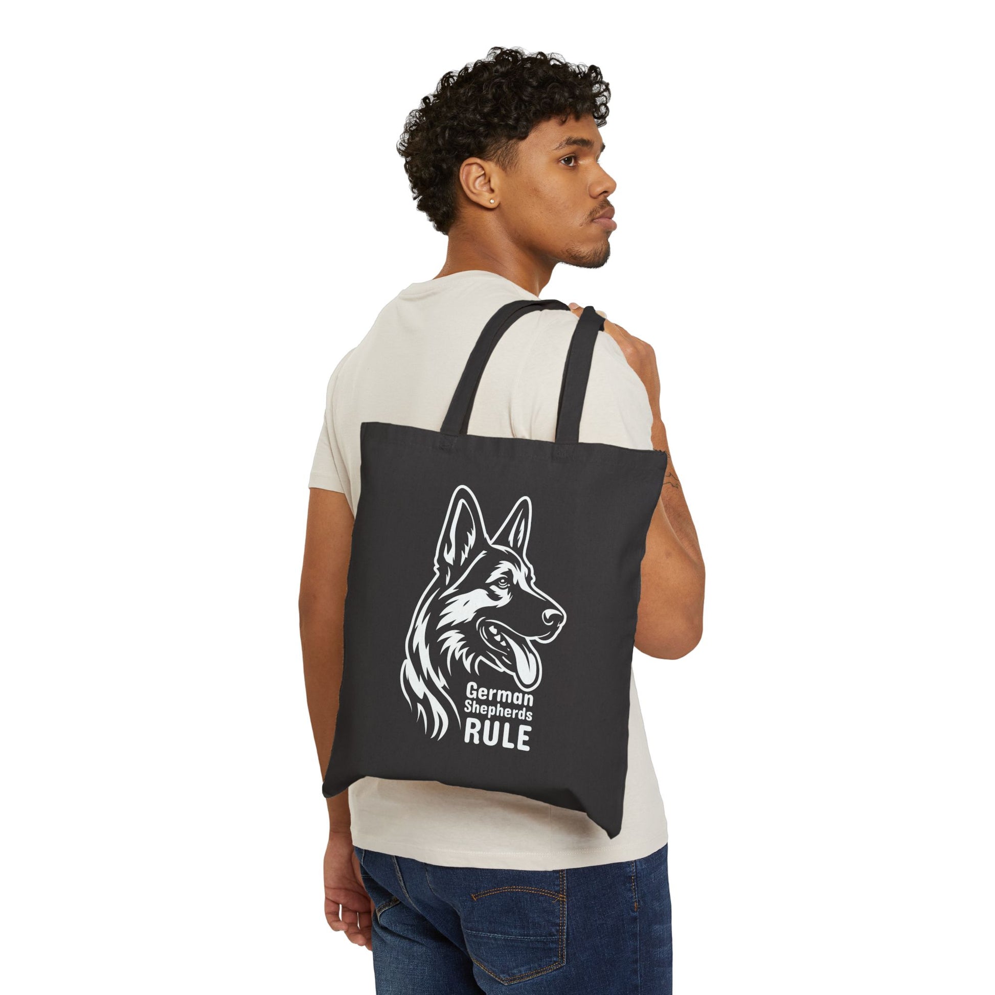 Man carrying a black tote bag with a German Shepherd design and text.