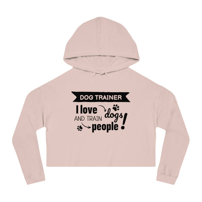 Pink cropped hoodie with text 'Dog Trainer I love dogs and train people' on a white background