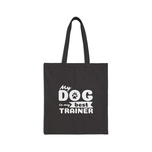 Black tote bag with 'My dog is my best trainer' text on a white background