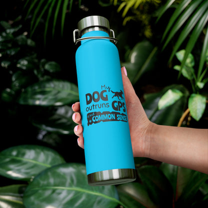 Blue water bottle with text held in front of green leaves