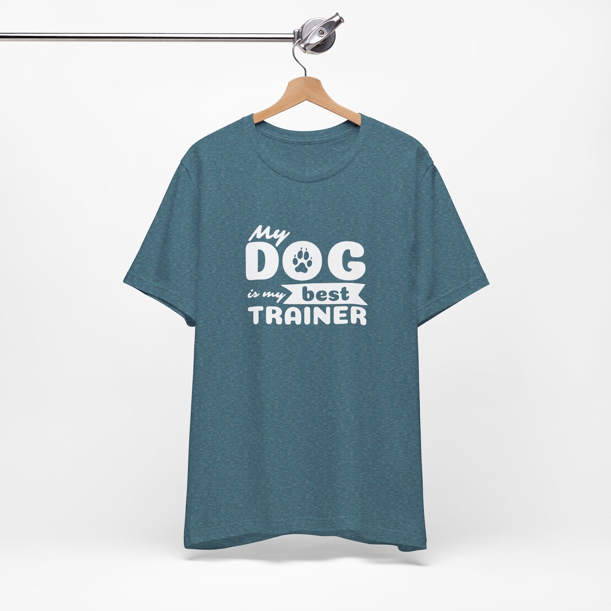 Blue t-shirt with 'My dog is my best trainer' text on a hanger against a white background