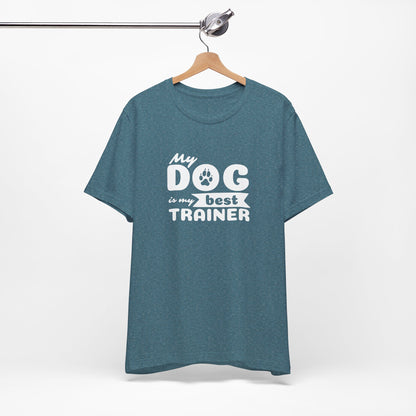 Blue t-shirt with 'My dog is my best trainer' text on a hanger against a white background