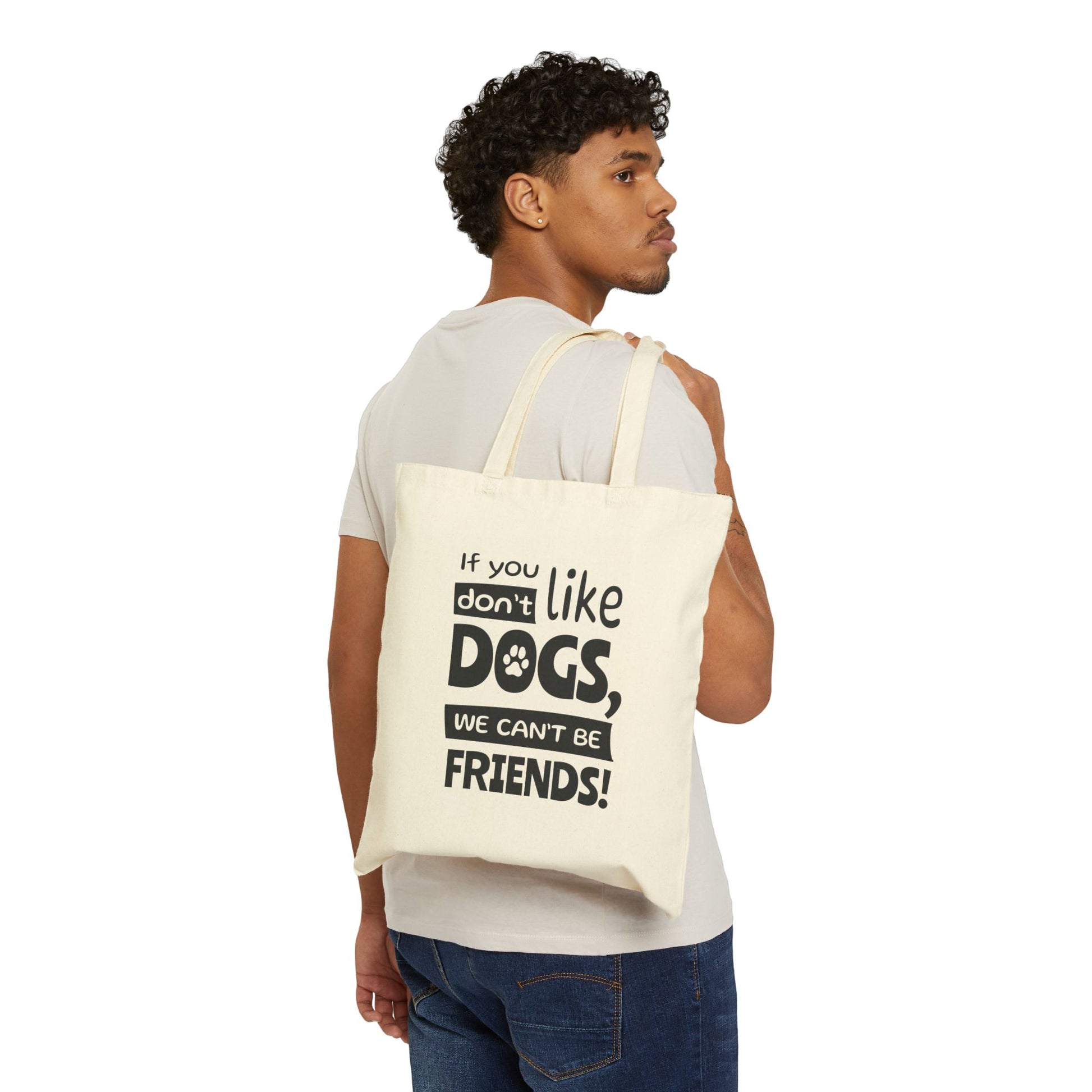 Man carrying a tote bag with text 'If you don't like dogs, we can't be friends!' on a white background