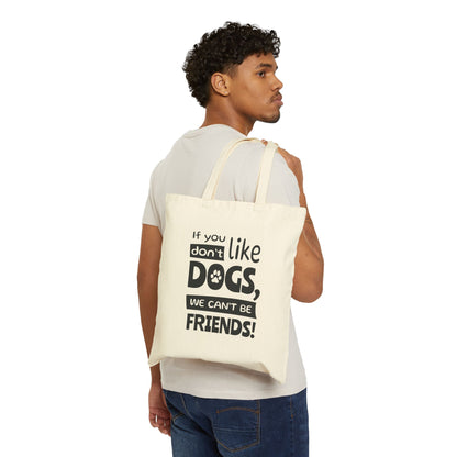 Man carrying a tote bag with text 'If you don't like dogs, we can't be friends!' on a white background