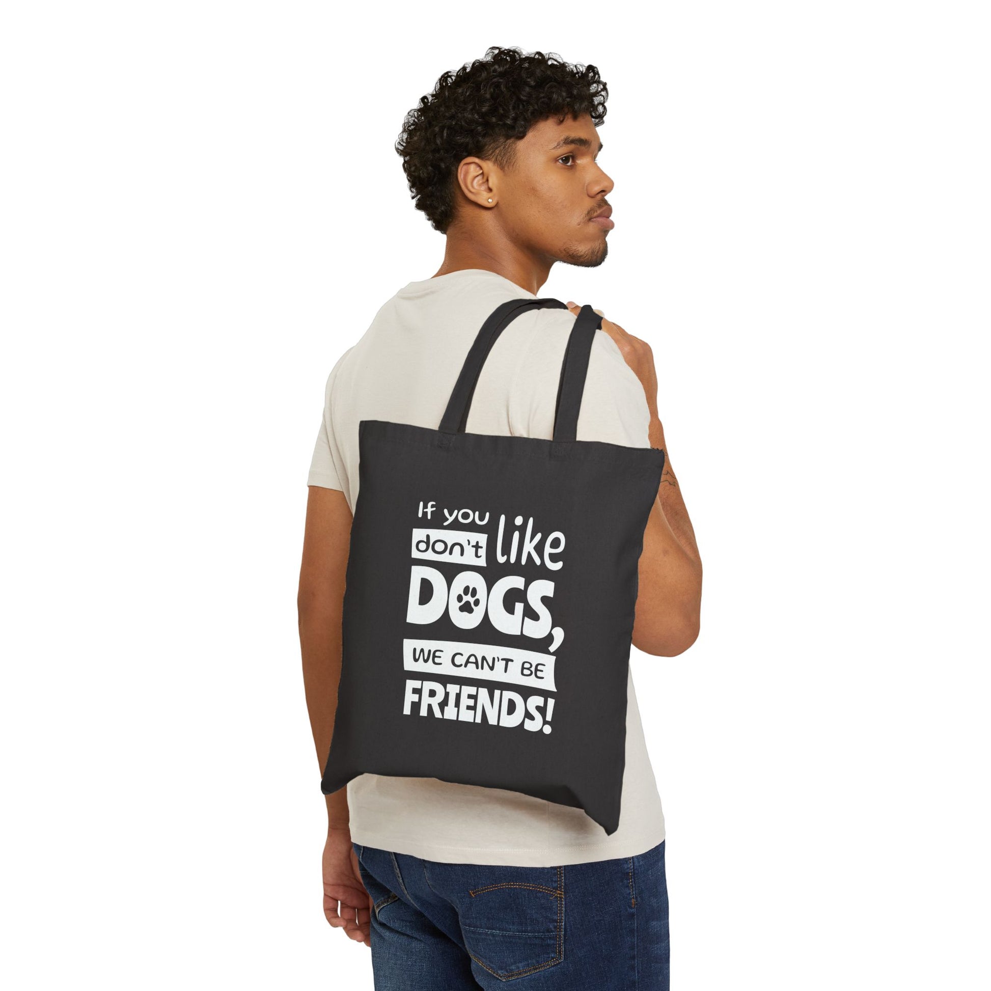 Man carrying a black tote bag with text, white background