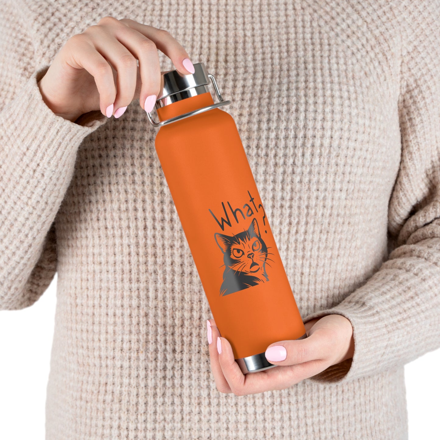 Person holding an orange water bottle with a cat graphic and text.