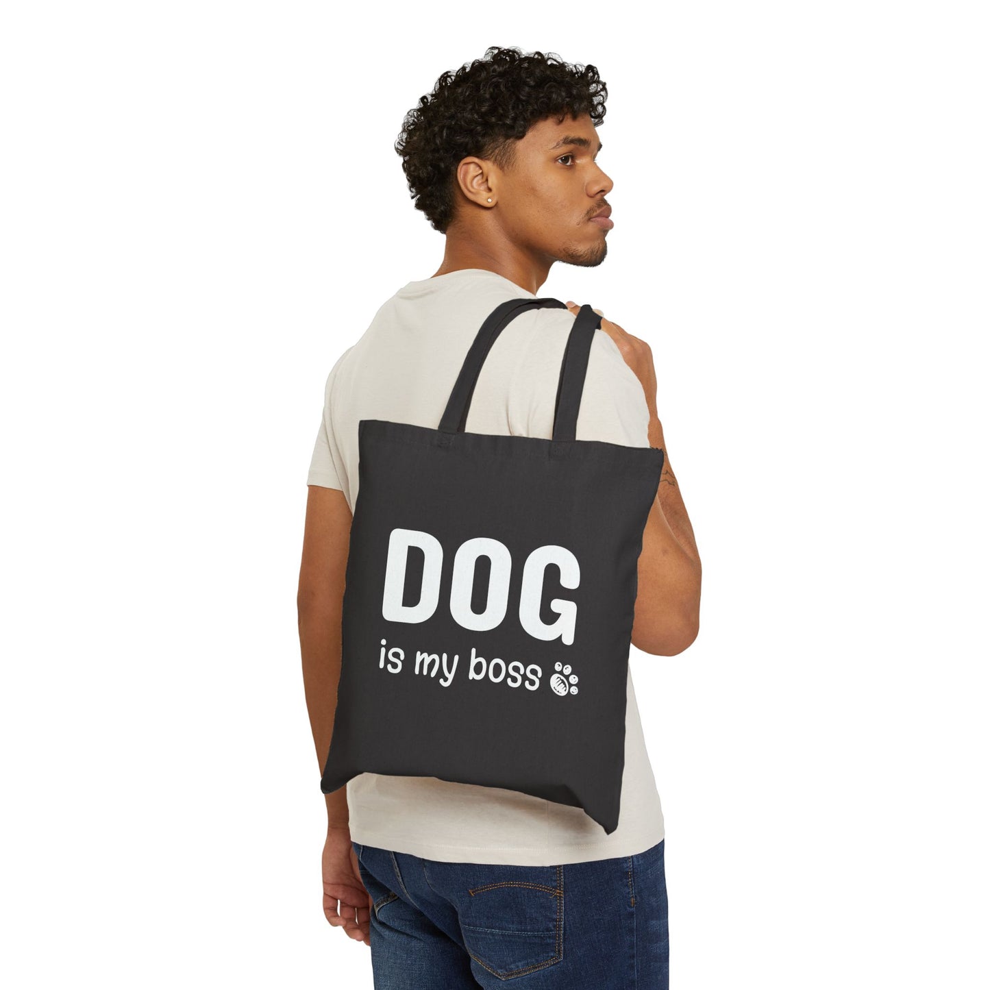 Man carrying a black tote bag with 'DOG is my boss' text on a white background