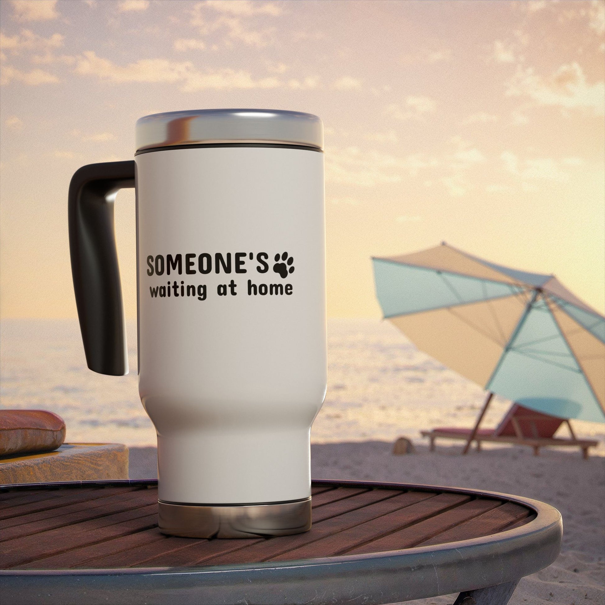 White travel mug with text on a beach table with an umbrella in the background