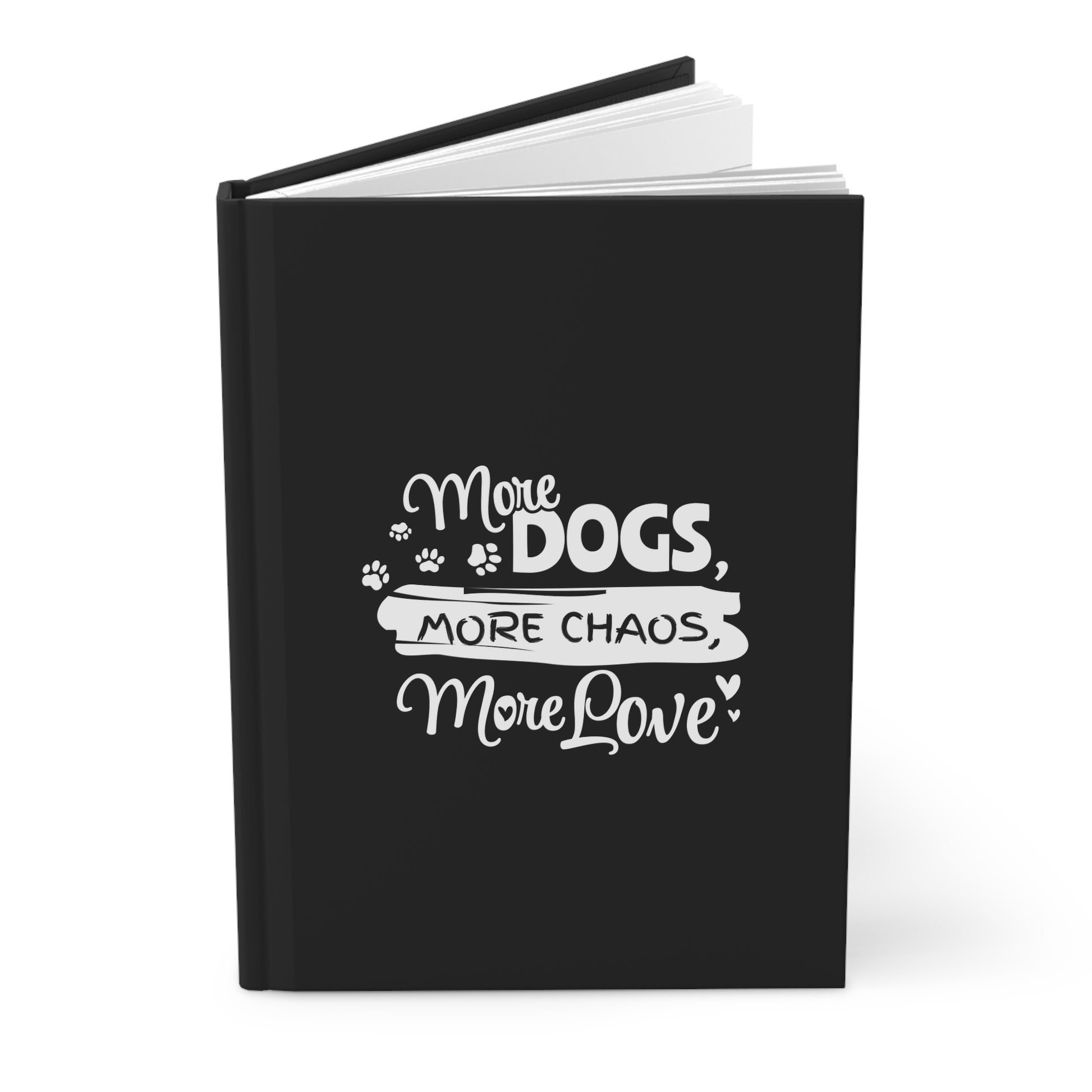 Black notebook with white text 'More Dogs, More Chaos, More Love' on a white background