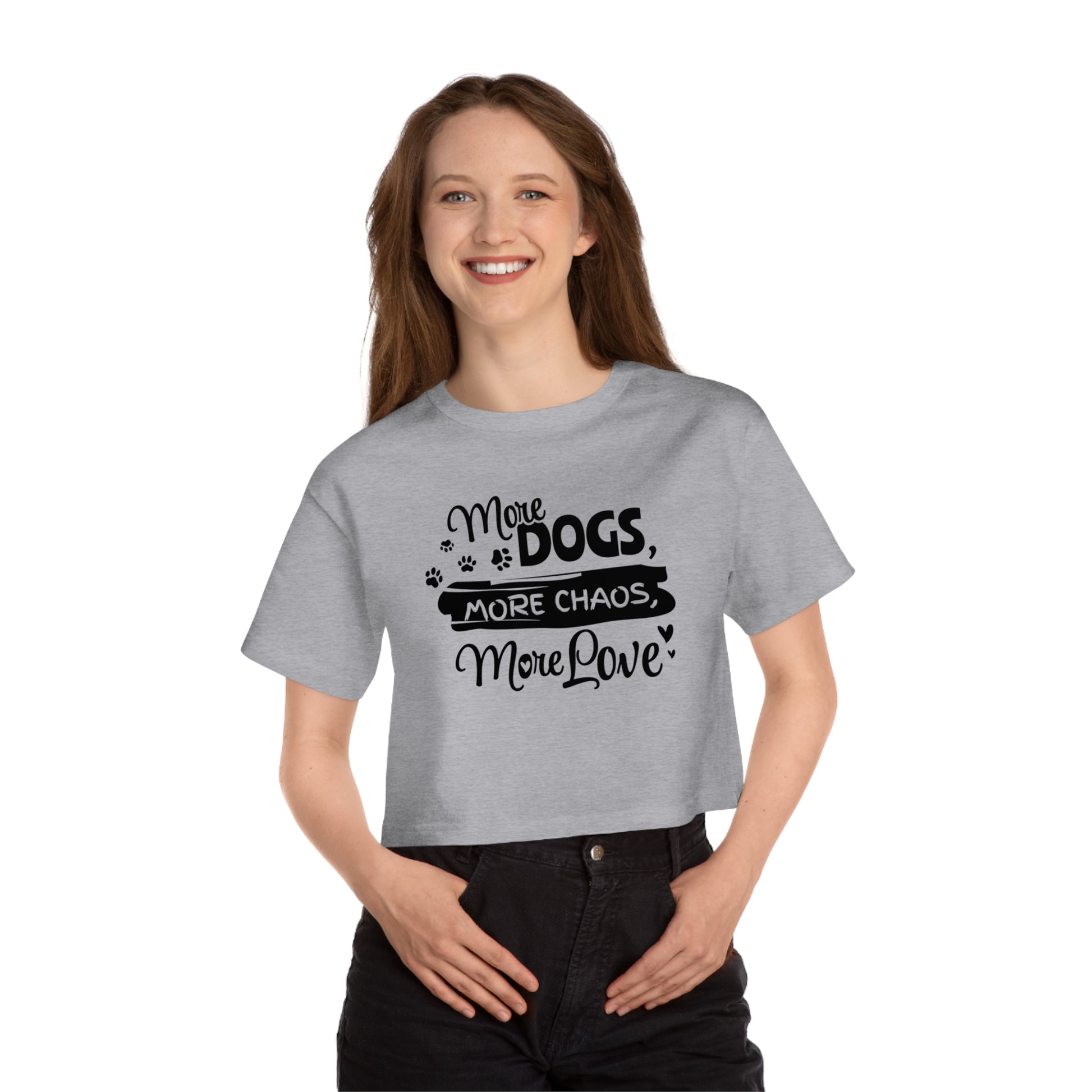 Person wearing a gray t-shirt with text 'More dogs, more chaos, more love' on a white background