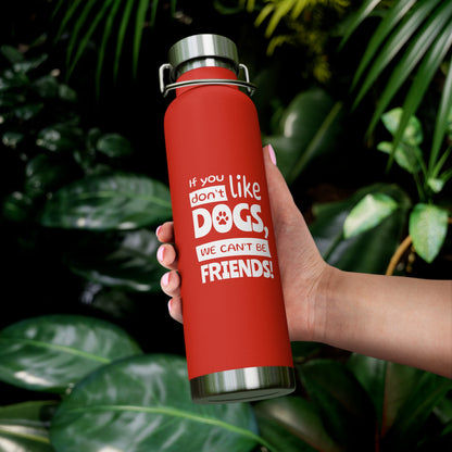 Red water bottle with a humorous text design held by a hand against a leafy green background