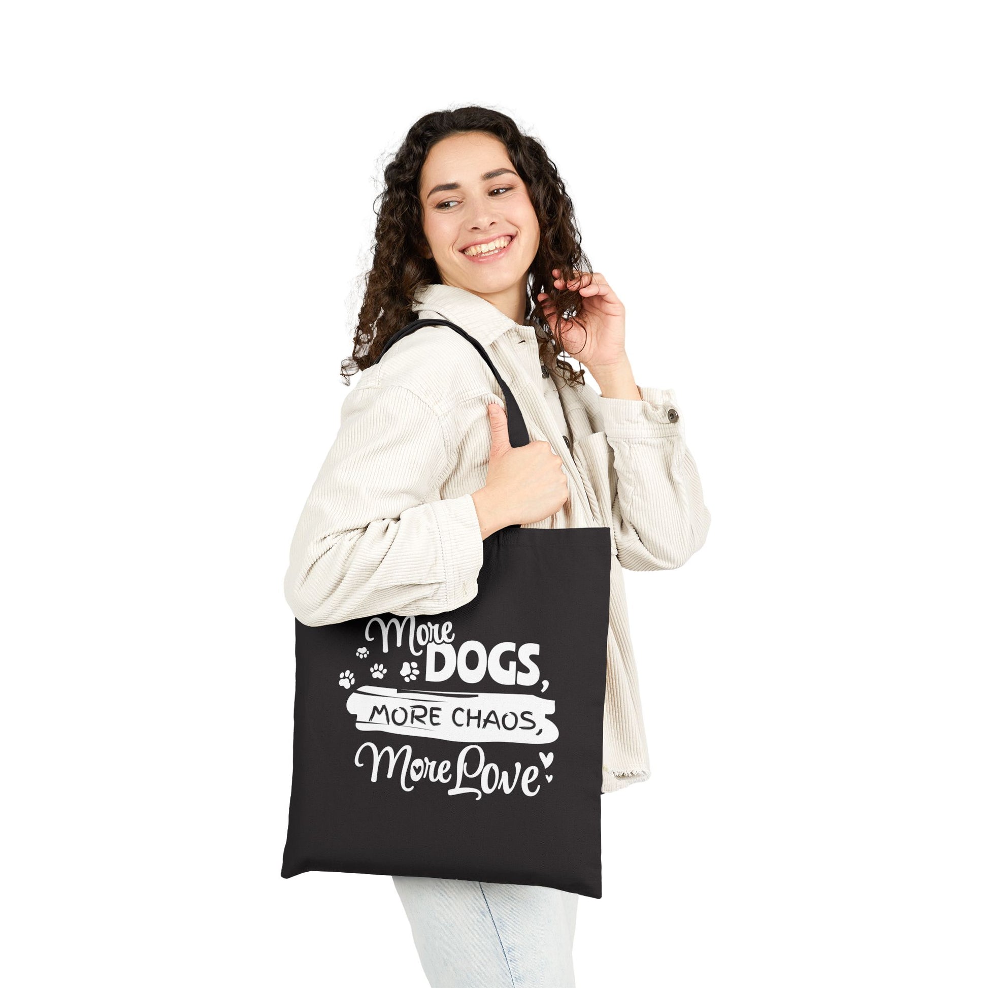 Woman holding a black tote bag with text and paw prints on a white background