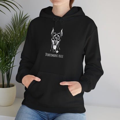 Person wearing a black hoodie with a dog graphic and 'Dobermans Rule' text, standing indoors.