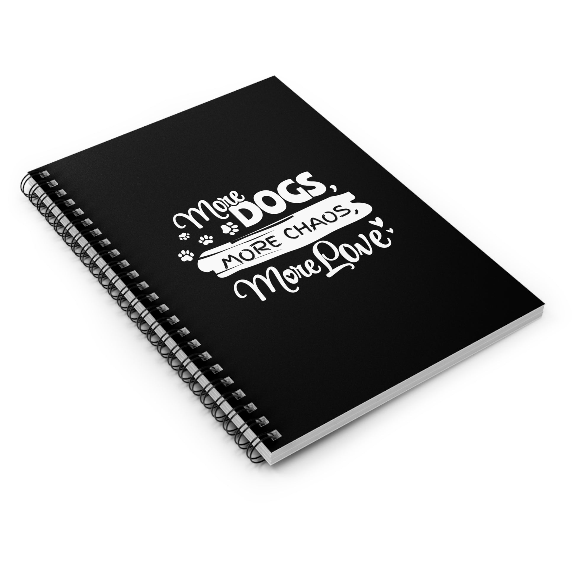 Black notebook with white text 'More Dogs, More Chaos, More Love' on a white background
