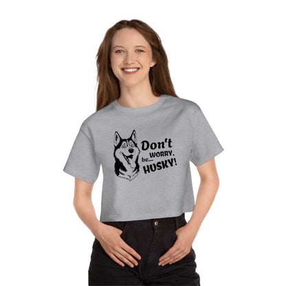 Person wearing a gray t-shirt with a husky graphic and text on a white background
