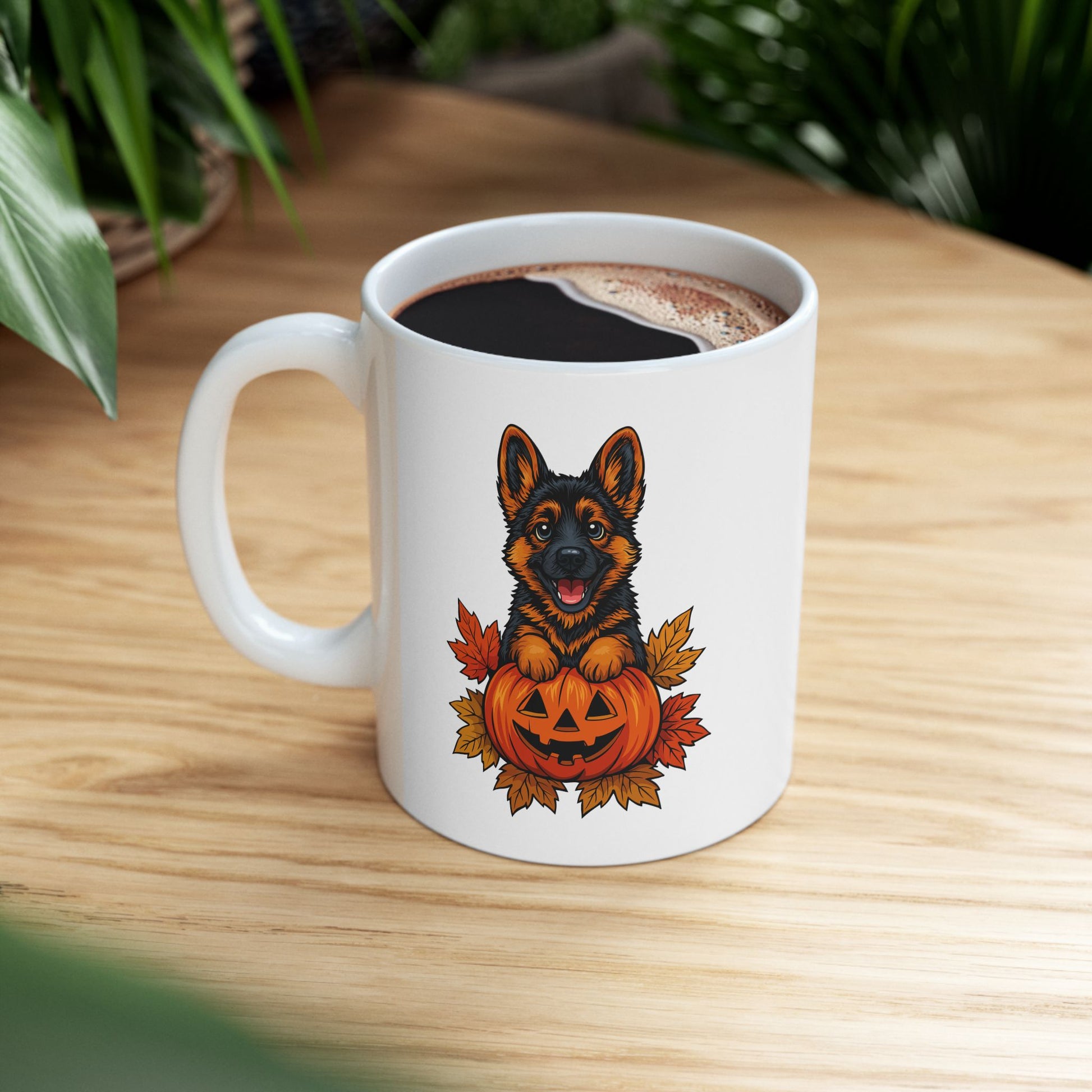 White mug with a dog in a pumpkin design on a wooden table