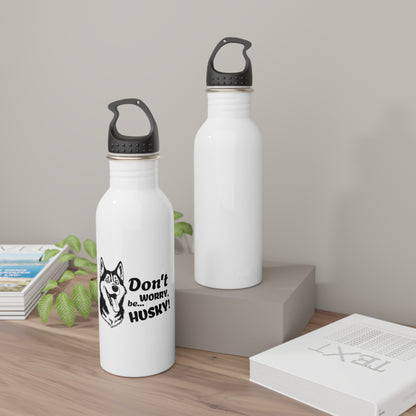 Two white water bottles with black lids on a wooden surface.