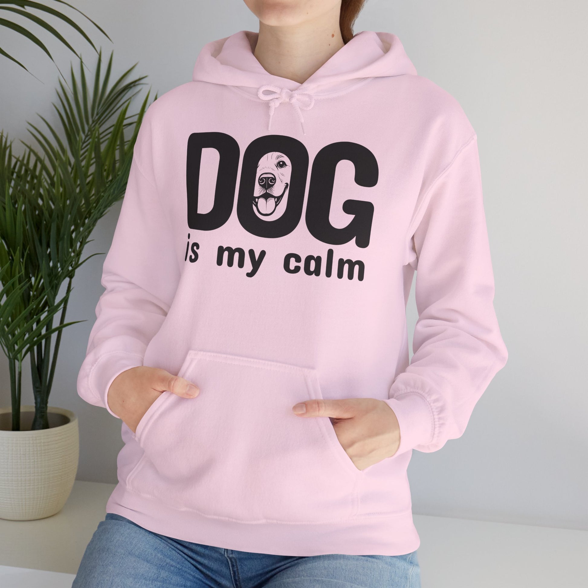 Person wearing a pink hoodie with 'DOG is my calm' text and dog graphic.