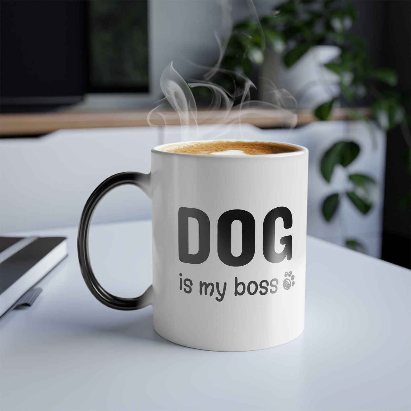 Mug with 'DOG is my boss' text on a desk with steam rising from it
