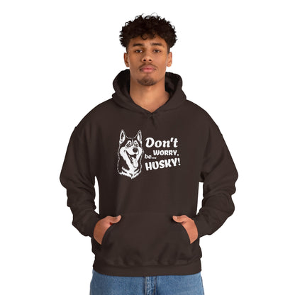 Person wearing a black hoodie with a husky graphic and text on a white background