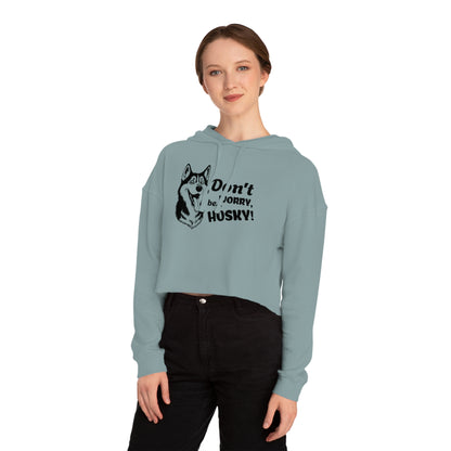 Woman wearing a light blue hoodie with a husky design and text on a white background