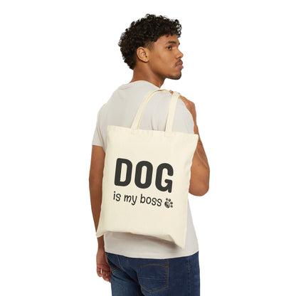 Man carrying a tote bag with 'DOG is my boss' text on a white background