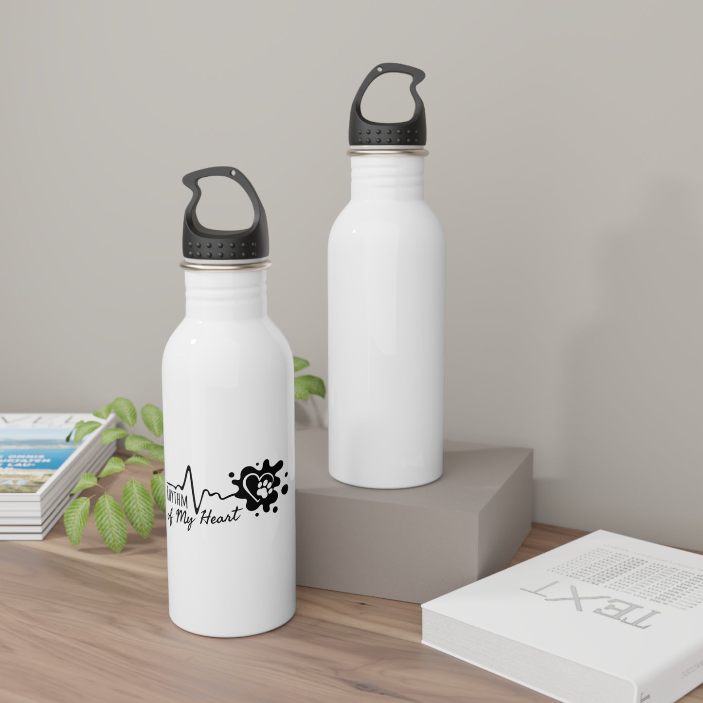 Two white water bottles with black lids on a wooden surface.