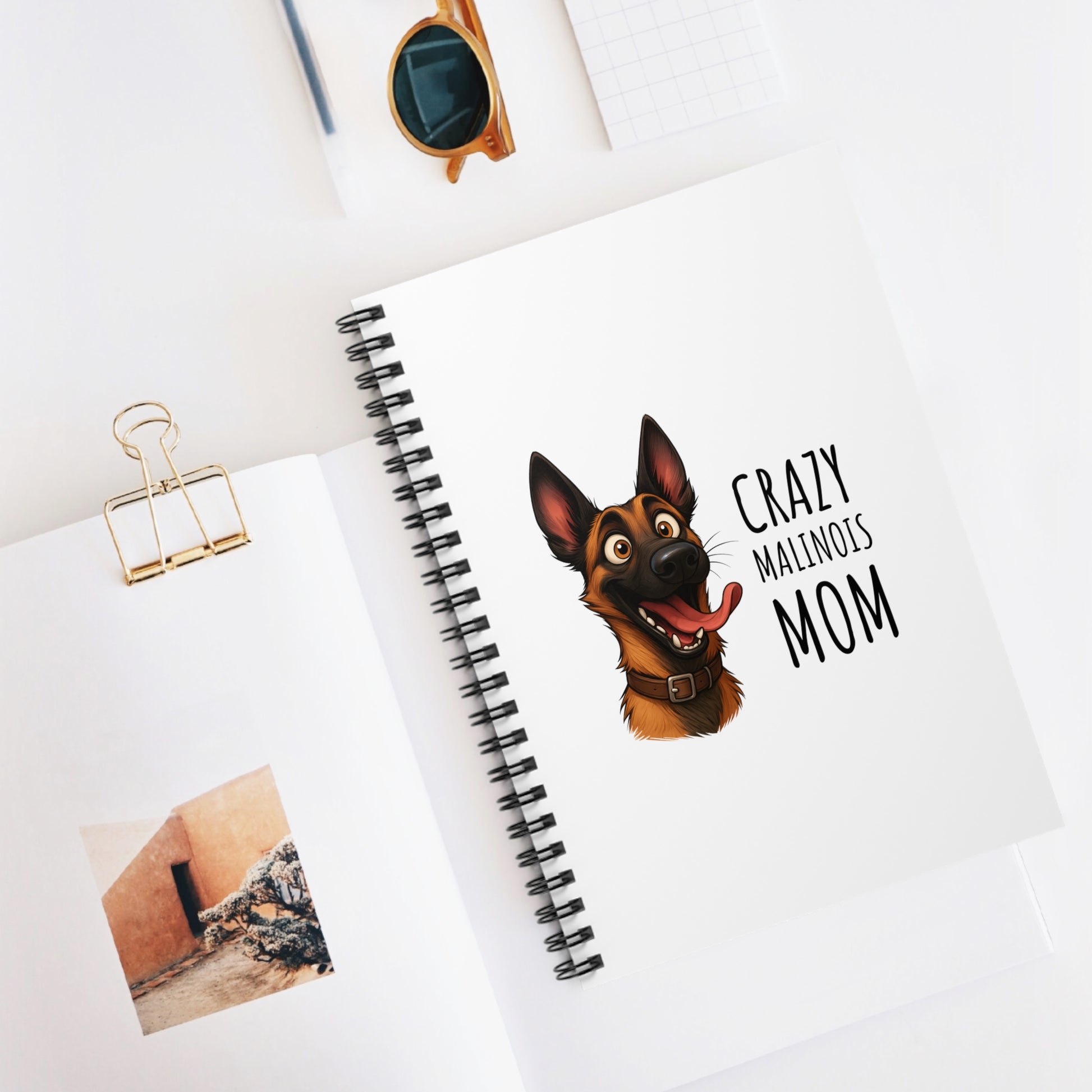 Notebook with a dog illustration and text on a white surface