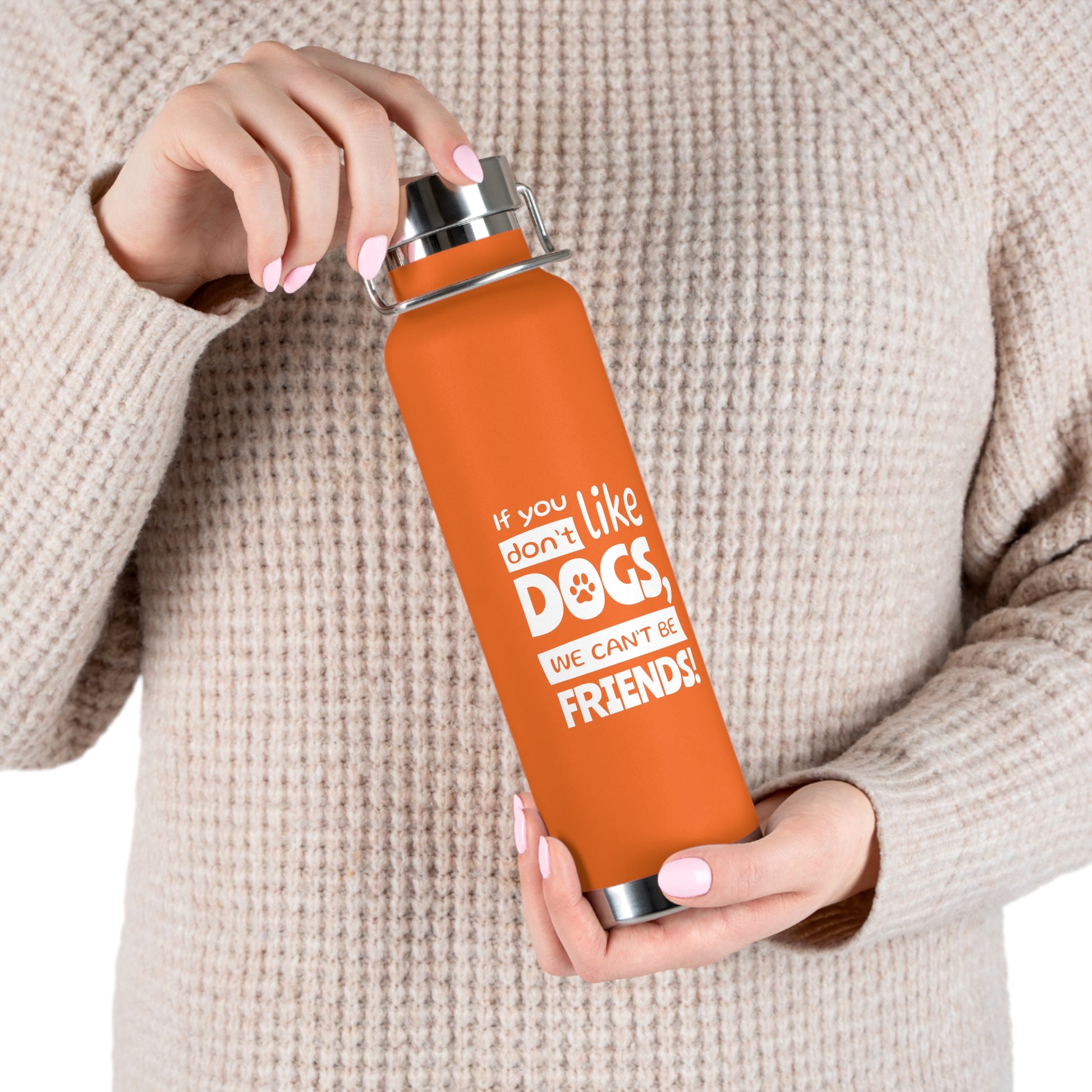 Person holding an orange water bottle with a humorous text design.