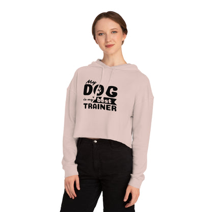 Person wearing a light pink hoodie with 'My dog is my best trainer' text on a white background