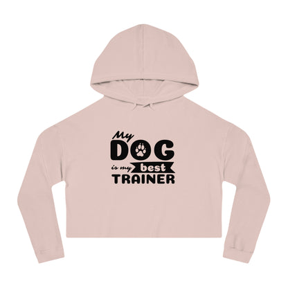 Pink cropped hoodie with 'My dog is my best trainer' text on a white background