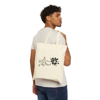 Man carrying a white tote bag with a design and text on a white background