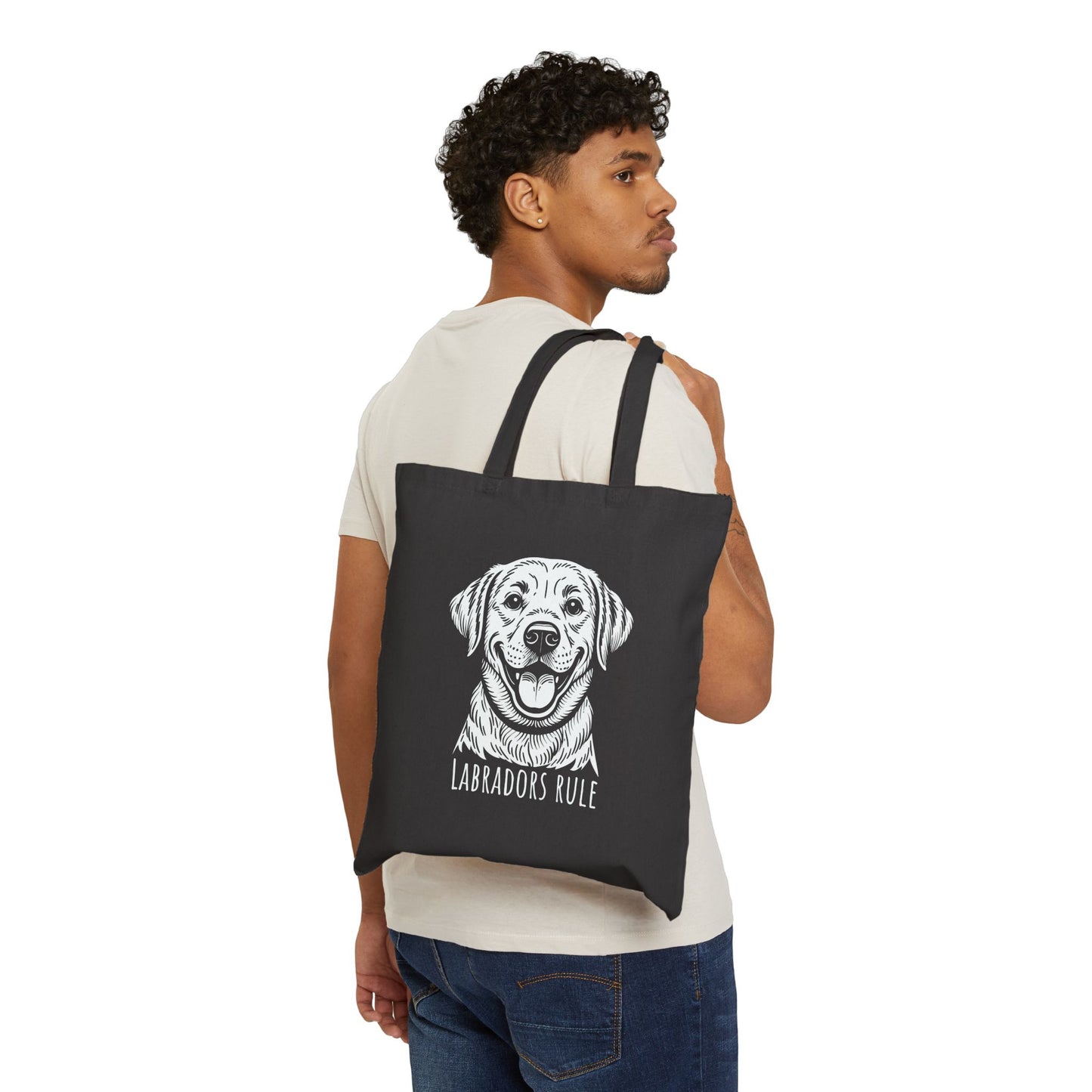 Man carrying a black tote bag with a dog illustration and 'Labradors Rule' text on a white background