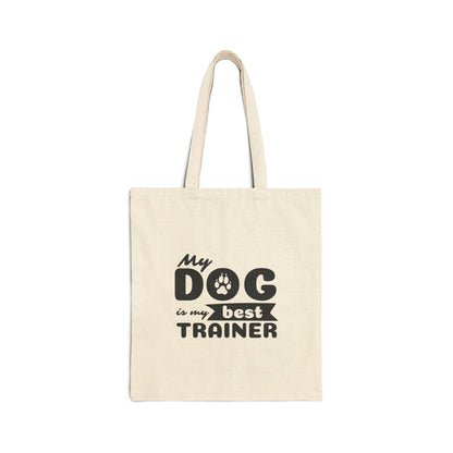 Beige tote bag with 'My dog is my best trainer' text on a white background