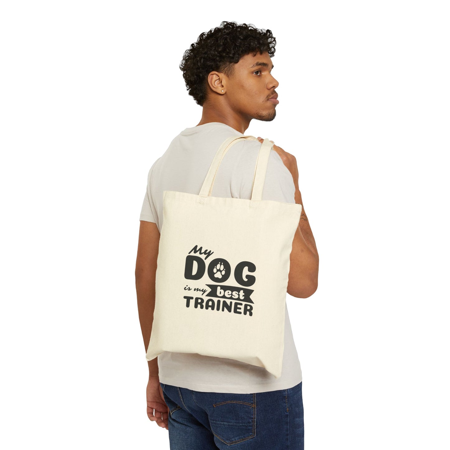 Man carrying a tote bag with 'My dog is my best trainer' text on a white background