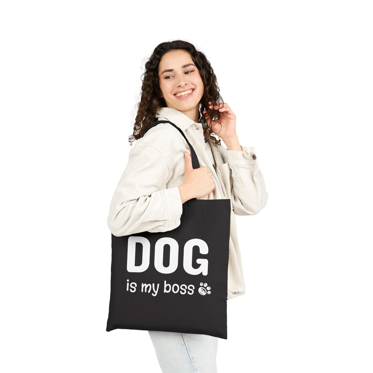 Woman holding a black tote bag with 'DOG is my boss' text on a white background
