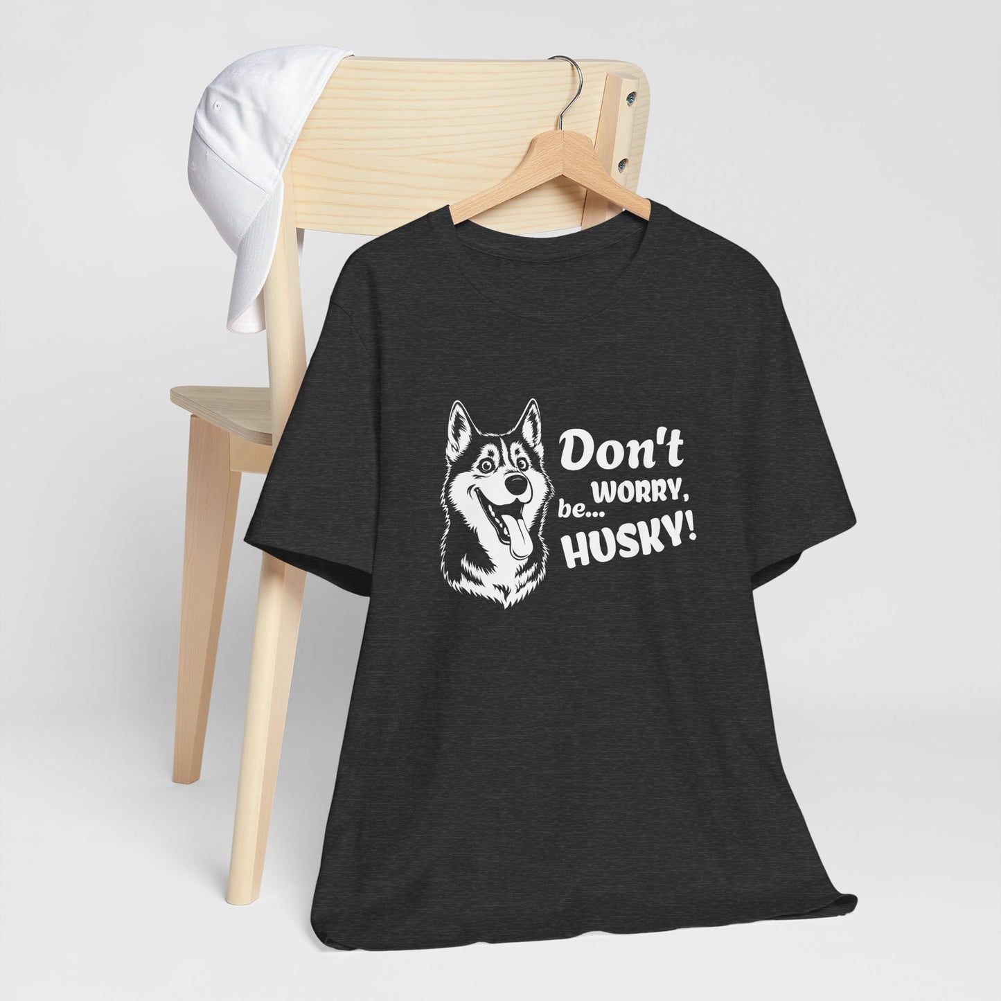 Black t-shirt with husky graphic and text on a wooden chair against a white background